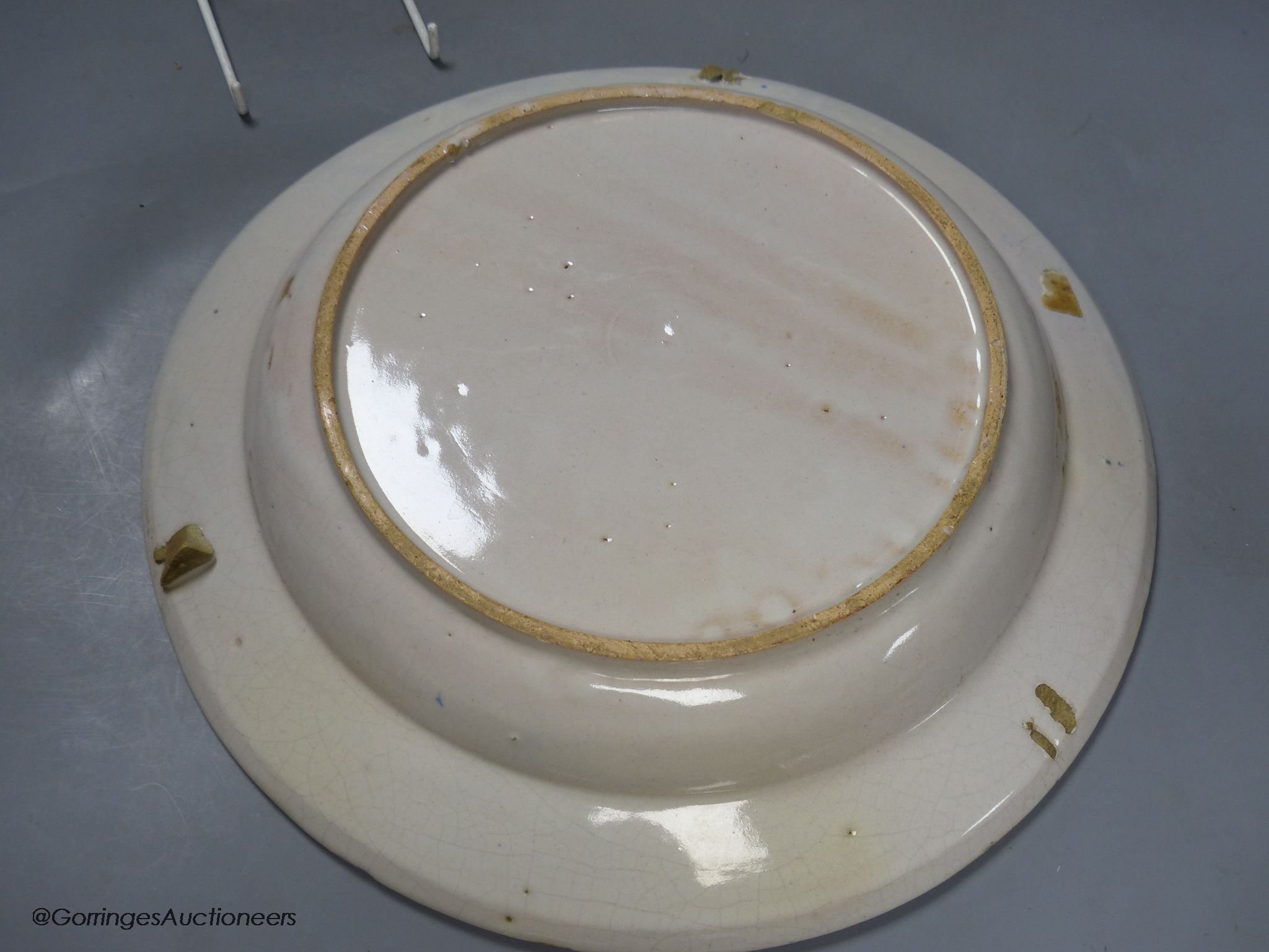 A pair of Continental polychrome faience chargers, late 19th century, height 33cm - one cracked